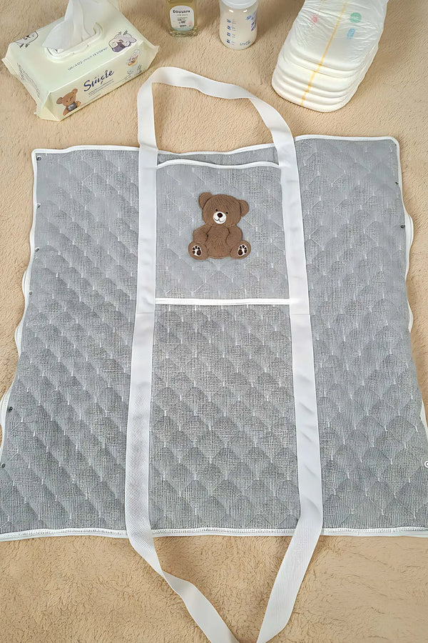 Mehrzweck-Pflegetasche und Wickelunterlage mit Teddybär-Motiv