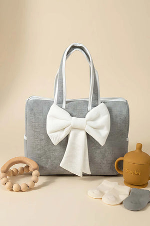 Wickeltasche mit Schleife und weißem Band für Mutter und Baby