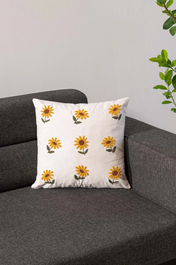 Cremefarbener Hintergrund, Sonnenblumenmuster, dekorativer Leinenkissenbezug mit Lochstickerei.